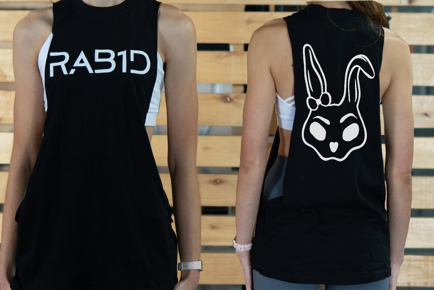 Black womens tank top with 'RAB1D' on the front and a rabbit face design on the back, worn by two people.